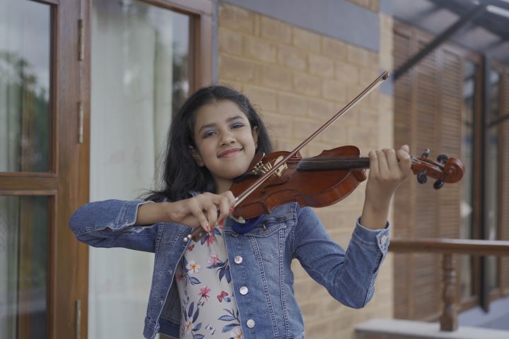 Mahati playing violin